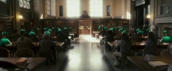 Movie still from “The Box” (2009), directed by Richard Kelly – A group of people sitting at tables in a library; Extreme Wide shot, High angle