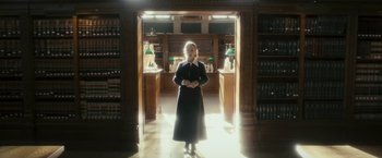 Movie still from “The Box” (2009), directed by Richard Kelly – A woman standing in a room with books on the floor; Wide shot, Low angle