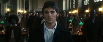 Movie still from “The Box” (2009), directed by Richard Kelly – A man in a crowd of people; Close Up shot, Over the shoulder angle