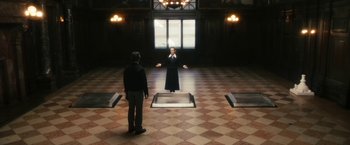 Movie still from “The Box” (2009), directed by Richard Kelly – A man and a woman standing in front of an open window; Wide shot, High angle