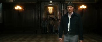 Movie still from “The Box” (2009), directed by Richard Kelly – A group of people standing in front of a man; Medium shot, Over the shoulder angle