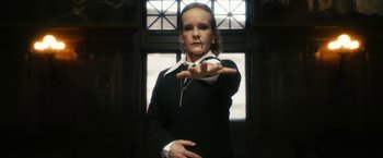 Movie still from “The Box” (2009), directed by Richard Kelly – A woman in a black shirt is holding her hand out; Medium shot, Low angle