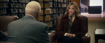 Movie still from “The Box” (2009), directed by Richard Kelly – A woman in a brown coat sitting next to a man in a suit and tie; Medium shot, Over the shoulder angle