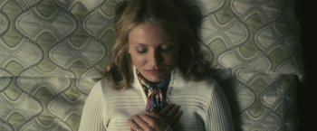 Movie still from “The Box” (2009), directed by Richard Kelly – A woman with her hands clasped in front of her chest; Close Up shot, Overhead angle