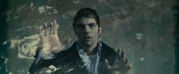 Movie still from “The Box” (2009), directed by Richard Kelly – A man standing in the middle of a body of water; Close Up shot, Overhead angle