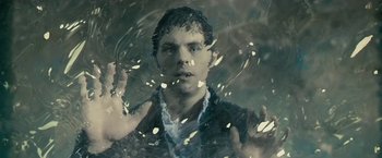 Movie still from “The Box” (2009), directed by Richard Kelly – A man standing in front of a glass window; Close Up shot, Overhead angle