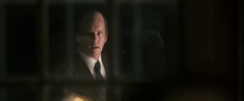 Movie still from “The Box” (2009), directed by Richard Kelly – A man wearing a suit and tie in front of a window; Close Up shot, Over the shoulder angle