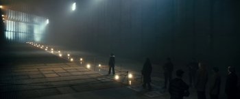Movie still from “The Box” (2009), directed by Richard Kelly – A group of people standing in the dark; Extreme Wide shot, High angle