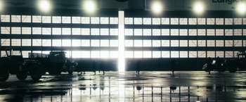 Movie still from “The Box” (2009), directed by Richard Kelly – A large building with lights on the outside of the building; Extreme Wide shot, Low angle
