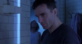 Movie still from “The Boxer” (1997), directed by Jim Sheridan – A man and a woman in a dark room; Close Up shot, Low angle
