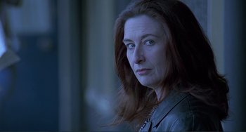 Movie still from “The Boxer” (1997), directed by Jim Sheridan – A person with long hair; Close Up shot, Low angle