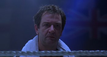 Movie still from “The Boxer” (1997), directed by Jim Sheridan – A person wearing a towel; Close Up shot, Low angle