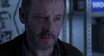 Movie still from “The Boxer” (1997), directed by Jim Sheridan – A person with a beard; Close Up shot, Over the shoulder angle