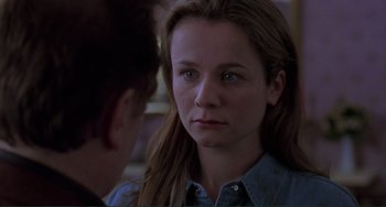 Movie still from “The Boxer” (1997), directed by Jim Sheridan – A young woman looking at a young man in front of a mirror; Close Up shot, Over the shoulder angle