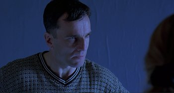Movie still from “The Boxer” (1997), directed by Jim Sheridan – A person wearing a sweater; Close Up shot, Low angle