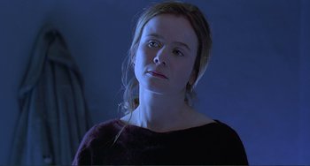 Movie still from “The Boxer” (1997), directed by Jim Sheridan – A young woman is looking at the camera; Close Up shot, Low angle