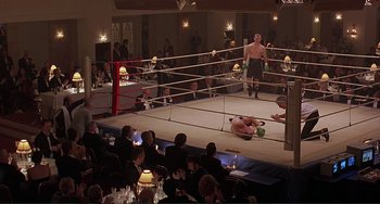 Movie still from “The Boxer” (1997), directed by Jim Sheridan – A boxing match in a boxing ring in front of an audience; Wide shot, High angle