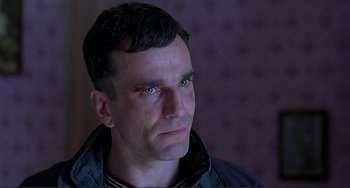 Movie still from “The Boxer” (1997), directed by Jim Sheridan – A person looking at the camera; Close Up shot, Low angle