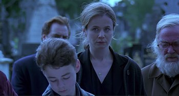 Movie still from “The Boxer” (1997), directed by Jim Sheridan – A woman and a boy standing next to each other; Close Up shot, Over the shoulder angle