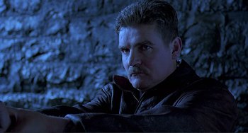 Movie still from “The Boxer” (1997), directed by Jim Sheridan – A person wearing a leather jacket; Close Up shot, Low angle