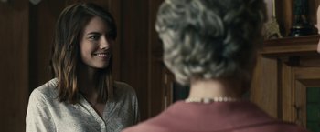 Movie still from “The Boy” (2016), directed by William Brent Bell – A young woman is looking at an older woman in the mirror; Close Up shot, Over the shoulder angle