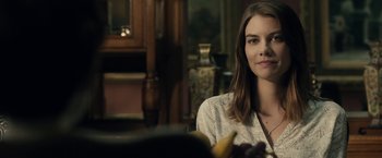 Movie still from “The Boy” (2016), directed by William Brent Bell – A woman sitting at a table with a banana in front of her face; Close Up shot, Over the shoulder angle