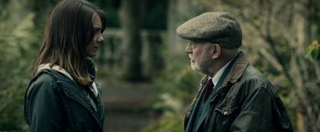 Movie still from “The Boy” (2016), directed by William Brent Bell – An older man and a young woman talking to each other; Close Up shot, Over the shoulder angle
