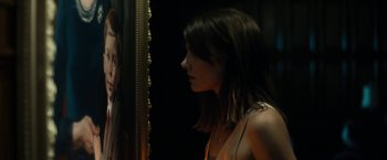 Movie still from “The Boy” (2016), directed by William Brent Bell – A woman standing in front of a mirror looking at herself in the mirror; Close Up shot, Over the shoulder angle
