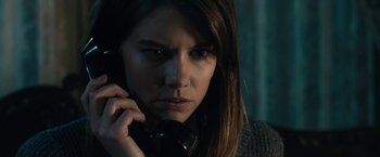 Movie still from “The Boy” (2016), directed by William Brent Bell – A person talking on a cell phone; Close Up shot, Over the shoulder angle