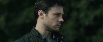 Movie still from “The Boy” (2016), directed by William Brent Bell – A person wearing a jacket; Close Up shot, Over the shoulder angle