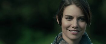 Movie still from “The Boy” (2016), directed by William Brent Bell – A woman smiling for the camera; Close Up shot, Over the shoulder angle