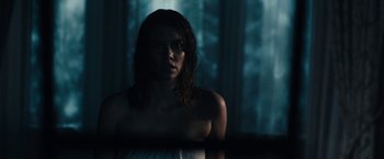 Movie still from “The Boy” (2016), directed by William Brent Bell – A woman with wet hair standing next to a window; Close Up shot, Low angle