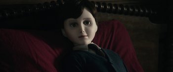 Movie still from “The Boy” (2016), directed by William Brent Bell – A doll sitting on a chair; Close Up shot, High angle