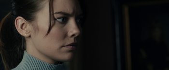 Movie still from “The Boy” (2016), directed by William Brent Bell – A person looking at the camera; Close Up shot, Over the shoulder angle