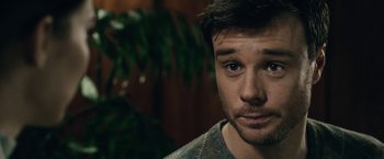 Movie still from “The Boy” (2016), directed by William Brent Bell – A person looking at the camera; Close Up shot, Over the shoulder angle