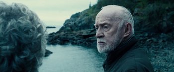 Movie still from “The Boy” (2016), directed by William Brent Bell – An old man with a beard and a white beard; Close Up shot, Over the shoulder angle