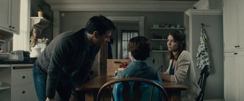 Movie still from “The Boy” (2016), directed by William Brent Bell – Two people sitting at a table talking to each other; Medium shot, Over the shoulder angle