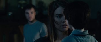 Movie still from “The Boy” (2016), directed by William Brent Bell – A person in a dark room; Close Up shot, Over the shoulder angle