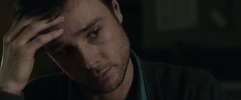 Movie still from “The Boy” (2016), directed by William Brent Bell – A person with a beard; Close Up shot, Over the shoulder angle