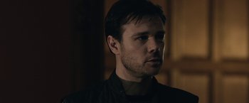 Movie still from “The Boy” (2016), directed by William Brent Bell – A person wearing a black shirt; Close Up shot, Over the shoulder angle