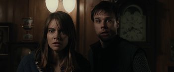 Movie still from “The Boy” (2016), directed by William Brent Bell – A man and a woman standing next to each other; Close Up shot, Over the shoulder angle