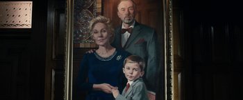 Movie still from “The Boy” (2016), directed by William Brent Bell – A painting of an older couple and a young boy; Close Up shot, Low angle