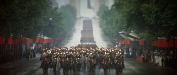 Movie still from “The Brain” (1969), directed by Gérard Oury – A large group of people on horses in a parade; Extreme Wide shot, High angle