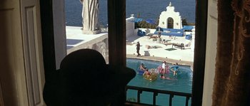 Movie still from “The Brain” (1969), directed by Gérard Oury – A group of people swimming in a swimming pool; Extreme Wide shot, High angle