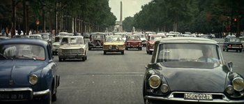 Movie still from “The Brain” (1969), directed by Gérard Oury – A bunch of cars that are on the street; Extreme Wide shot, High angle