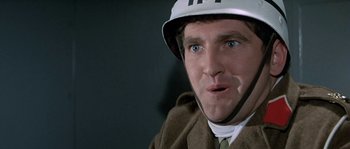 Movie still from “The Brain” (1969), directed by Gérard Oury – A person wearing a helmet; Close Up shot, Low angle