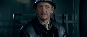 Movie still from “The Brain” (1969), directed by Gérard Oury – A person wearing a helmet; Close Up shot, Low angle