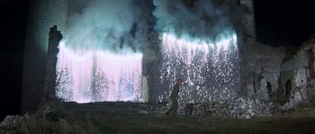 Movie still from “The Brain” (1969), directed by Gérard Oury – A man walking in front of a wall of smoke; Extreme Wide shot, Low angle