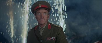 Movie still from “The Brain” (1969), directed by Gérard Oury – A person wearing a military uniform; Close Up shot, Low angle