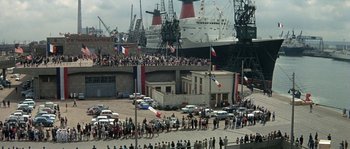 Movie still from “The Brain” (1969), directed by Gérard Oury – A crowd of people standing in front of a large ship; Extreme Wide shot, High angle